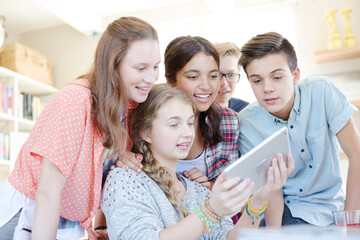 Group of teenagers taking selfie with digital tablet