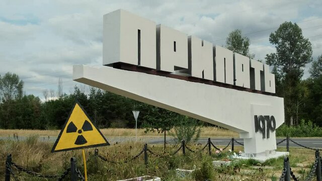 Pripyat road sign with radiation hazard, a ghost town near Chernobyl exclusion zone. Pripyat signpost close to the destroyed Reactor