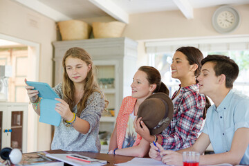 Fototapeta premium Group of smiling teenagers taking selfie in dining room