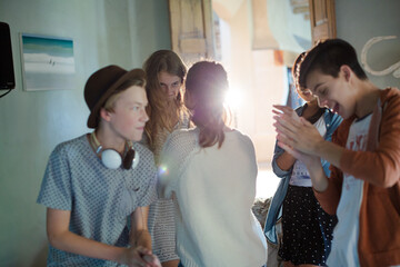 Group of teenagers dancing in living room