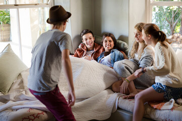 Group of teenagers sitting on sofa