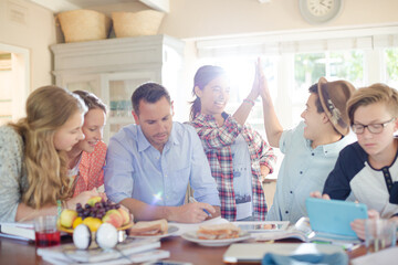 Group of teenagers doing high five in living room