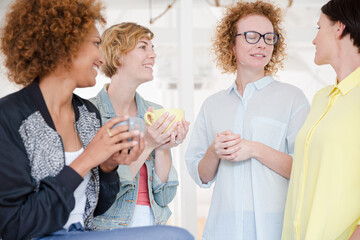 Women with coffe cup smiling in office