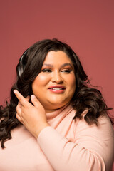 Studio shot of smiling woman with headphones