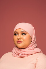 Studio portrait of woman in pink hijab