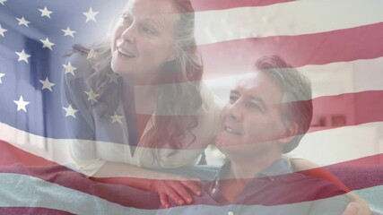 Animation of american flag blowing over smiling senior couple talking and embracing - Powered by Adobe