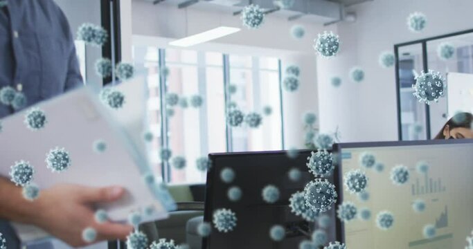 Animation of covid virus cells over diverse colleagues in face masks working in office - Powered by Adobe