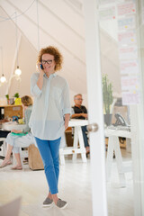 Portrait of woman talking on phone at office