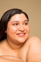 Studio portrait of young shirtless woman, headshot