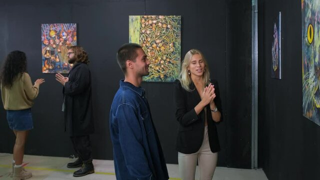young people are enjoying modern art in gallery with abstract pictures
