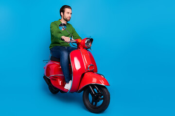 Full size photo of serious cool confident peaceful guy ride moped traveling road isolated on blue...