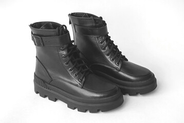 Women winter footwear on a white concrete background, modern style and elegant design of shoes