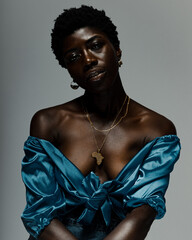 Studio portrait of young woman in blue silk top