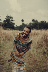 Portrait of woman in patterned dress standing in field