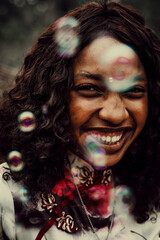 Close-up of smiling woman with soap bubbles