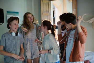 Group of teenagers dancing in living room