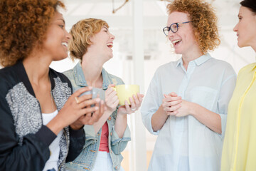 Women with coffe cup smiling in office