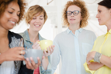 Women with coffe cup smiling in office