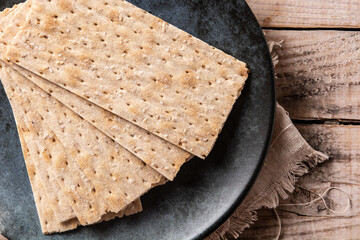Traditional matzah bread on rustic wooden table