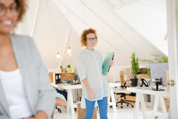 Fototapeta premium Woman walking and carrying laptop, joining colleague from office