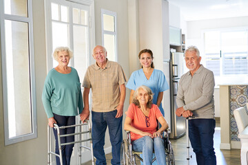 Group of seniors with wheelchairs and walking frames in the retirement home