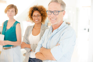 Colleagues  smiling in office, holding documents