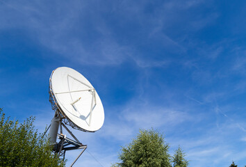 Big white satellite dish on a blue sky