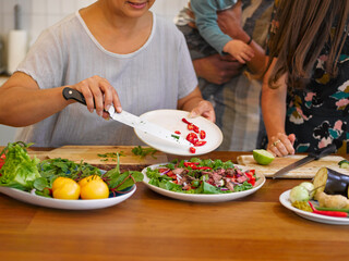 Close-up of family preparing food in kitchen