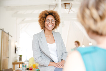 Portrait of young woman smiling at office