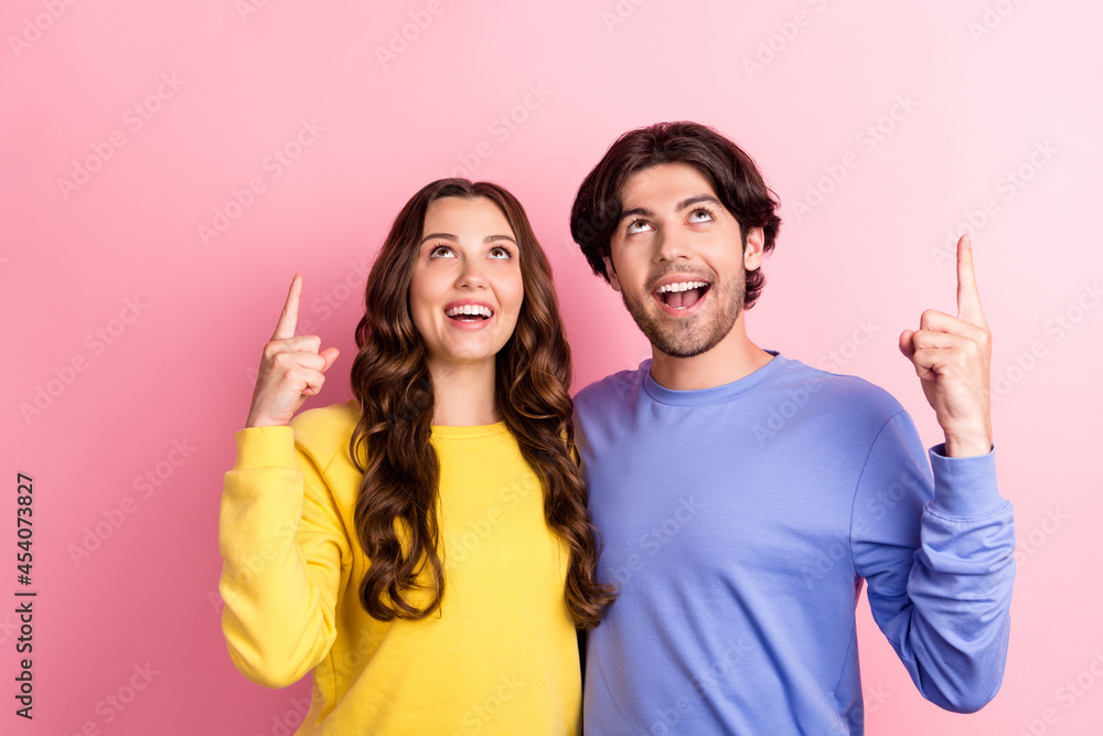 Sticker photo of young couple happy positive smile look indicate fingers empty space promo suggest sale isol