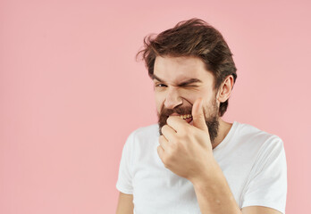 bearded man in white t-shirt emotions pink background fun