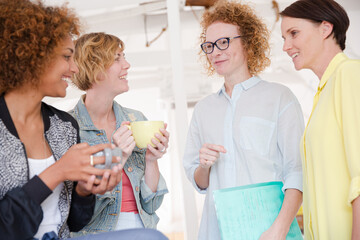 Women with coffe cup smiling in office