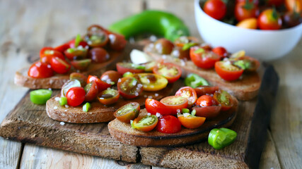Bruschetta with mini tomatoes on a wooden surface. Healthy snack. Diet food.