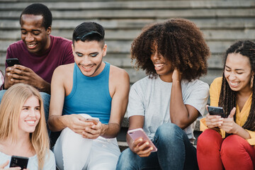 Young people having fun together with smartphone outdoor in the city - Focus on gay man face