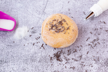 Obraz na płótnie Canvas icing sugar donuts with chocolate sprinkles on top