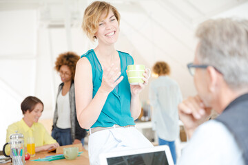 Fototapeta premium Man and woman sitting in office,smiling and talking