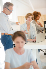 Office workers talking at desk