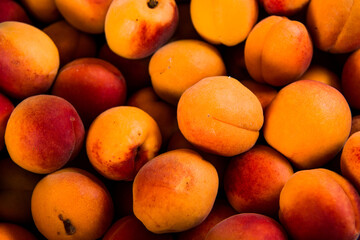 Close-up of fresh.Space for text top view. A group of ripe peaches on dark kitchen table.