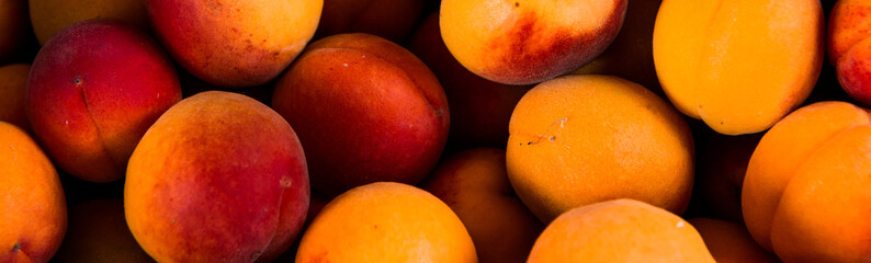 Close-up of fresh.Space for text top view. A group of ripe peaches on dark kitchen table.