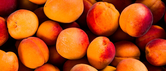 Close-up of fresh.Space for text top view. A group of ripe peaches on dark kitchen table.