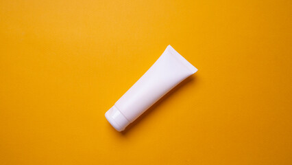 packaging of hand or face cream on yellow background