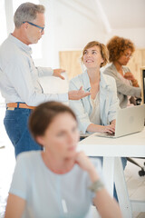 Office workers talking at desk