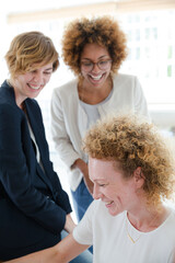 Women talking and smiling in office