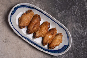 Fried chicken wings in a white cup. The view from the top. Space for text.