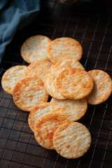 Crispy crackers on a black circle, black top view.