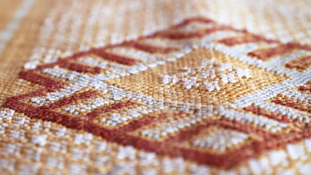 Detail of a handmade, traditional, Moroccan cactus silk (Sabra silk) rug, carpet. Macro closeup abstract geometric patterns, handwoven, shallow depth of field.