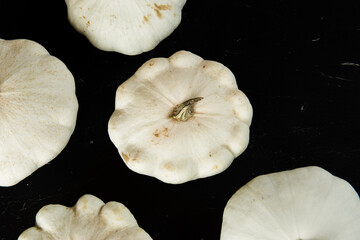 patison pumpkin squashed on dark kitchen table, whole bio raw vegetable brom village gardening