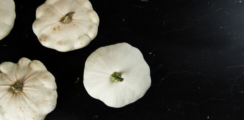 patison pumpkin squashed on dark kitchen table, whole bio raw vegetable brom village gardening