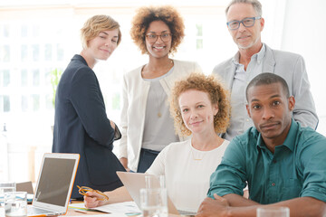 Portrait of office team smiling in conference room