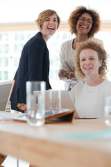 Women talking and smiling in office